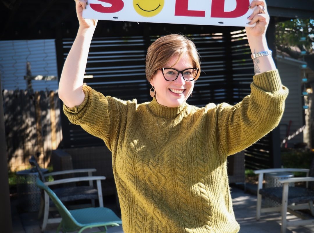 107-Emily Tupa holding SOLD sign — Black Hills real estate agent (Large)